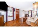 Living room with hardwood floors, light beige couch, and wooden coffee table at 1601 New York Ave., St Cloud, FL 34769