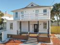 Two-story house with white exterior, brown deck, and black accents at 17 S Oleander Ave, Daytona Beach, FL 32118