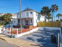 Two-story house with white exterior, large front yard, and parking at 17 S Oleander Ave, Daytona Beach, FL 32118