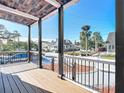 Front porch with wooden deck, black railings, and wood ceiling at 17 S Oleander Ave, Daytona Beach, FL 32118