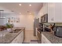 Modern kitchen featuring granite countertops and island with seating at 2229 Shadowland Loop, Winter Park, FL 32792