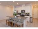Spacious kitchen with granite countertops and stainless steel appliances at 2229 Shadowland Loop, Winter Park, FL 32792