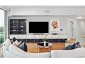 Spacious living room featuring a large TV and modern shelving at 260 S Osceola Ave # 1001, Orlando, FL 32801