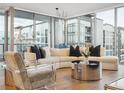 Living room with floor-to-ceiling windows and modern decor at 260 S Osceola Ave # 1001, Orlando, FL 32801