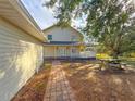 Brick pathway leads to two-story house with a porch at 2827 Sanctuary Ln, Winter Garden, FL 34787