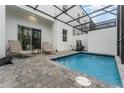 Private screened pool with patio furniture and lush landscaping at 388 Famagusta Dr, Davenport, FL 33896