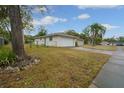Detached garage with a white door and grassy yard at 507 Applewood Ave, Altamonte Springs, FL 32714