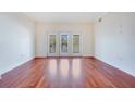 Spacious living room featuring hardwood floors and large windows at 630 Vassar St # 2310, Orlando, FL 32804