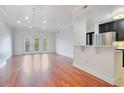 Bright living room with hardwood floors and access to a balcony at 630 Vassar St # 2310, Orlando, FL 32804