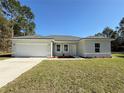 Newly built home with a two-car garage, and front landscaping at 6365 Sw 156 Th St St, Ocala, FL 34473