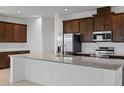 Bright kitchen with granite countertops, stainless steel appliances, and dark wood cabinetry at 7100 Cherry Pasture Rd, Groveland, FL 34736