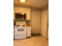 White kitchen with built in microwave and stove at 930 Brennam Pl, Longwood, FL 32750