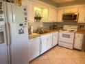 White kitchen with stainless steel appliances and ample counter space at 930 Brennam Pl, Longwood, FL 32750