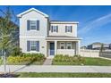 Two-story house with blue door, shutters, and landscaping at 15005 Lake Bessie Loop, Winter Garden, FL 34787