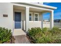 Modern front door with stone walkway and landscaping at 15005 Lake Bessie Loop, Winter Garden, FL 34787