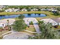 House on a lakefront lot with lush landscaping and other homes visible at 2641 Meadow View Ct, Kissimmee, FL 34746