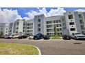 Apartment building exterior with parking and landscaping at 3151 Paradox Cir # 405, Kissimmee, FL 34746