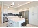Modern kitchen with white cabinets, stainless steel appliances, and an island at 3151 Paradox Cir # 405, Kissimmee, FL 34746