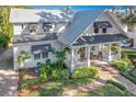 Stunning two-story house with a wrap-around porch and lush landscaping at 527 Broadway Ave, Orlando, FL 32803