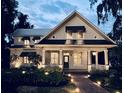 Inviting traditional home with a large front porch, manicured landscaping, and exterior lighting at 527 Broadway Ave, Orlando, FL 32803