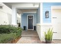 Charming blue home featuring a covered front porch and a welcoming entrance with brick pavers at 618 Windy Pine Way, Oviedo, FL 32765