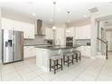 Spacious kitchen with white cabinetry, granite countertops, stainless steel appliances, and a large center island at 618 Windy Pine Way, Oviedo, FL 32765