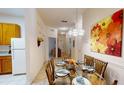 Bright dining area with glass table and wicker chairs at 702 Rum Run # 38702, Davenport, FL 33897