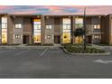 Contemporary townhome at dusk with parking at 7575 Brooklyn Dr, Kissimmee, FL 34747