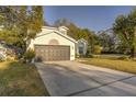 Two-story house with a dark brown garage door and manicured lawn at 7749 Brookway St, Orlando, FL 32817