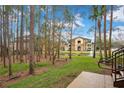 View of the apartment complex from a wooded area with a pond at 814 Crest Pines Dr # 937, Orlando, FL 32828