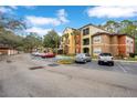 Parking lot view of the apartment complex with cars parked at 814 Crest Pines Dr # 937, Orlando, FL 32828