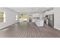 Open concept kitchen with white cabinets, island, and stainless steel appliances at 8549 Sw 129Th Ln, Ocala, FL 34473