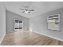 Living room with vinyl plank flooring and sliding glass doors to backyard at 1058 Florida Holly Dr, Orlando, FL 32811