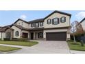 Two-story house with stone accents and a three-car garage at 11769 Hampstead St, Windermere, FL 34786