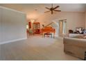 Bright living room with hardwood floors, a piano, and access to dining area at 1220 Alden Ter, Deltona, FL 32738