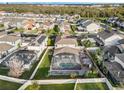 Aerial view of the backyard with a screened-in pool and lush green lawn at 14190 Dove Hollow Dr, Orlando, FL 32824