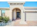 Front entryway with arched entry and brick walkway at 144 Trinity Ridge Cir, Davenport, FL 33897