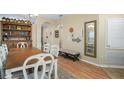 Elegant dining room with a large wooden table and a view of the entry way at 15208 Stonebriar Way, Orlando, FL 32826