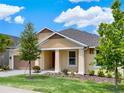 Tan house with brown roof, landscaping, and a two-car garage at 1593 Osprey View Dr, Apopka, FL 32703