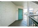 Apartment entryway with teal door and neutral colored walls at 2230 Cascades Blvd # 207, Kissimmee, FL 34741