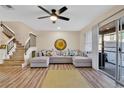 Spacious living room with L-shaped sofa, hardwood floors, and a ceiling fan at 2823 Boulder Falls Ct, Apopka, FL 32703