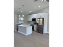 Modern kitchen featuring white cabinets, stainless steel appliances, and an island at 3 Fisher Loop Crse, Ocklawaha, FL 32179