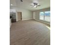 Spacious living area with light wood-look flooring and ceiling fan at 3 Fisher Loop Crse, Ocklawaha, FL 32179