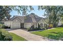 Two-story house with a three-car garage and well manicured lawn at 32604 View Haven Ln, Sorrento, FL 32776