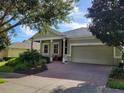 Charming one story house with a front porch and landscaped yard at 370 Silver Maple Rd, Groveland, FL 34736