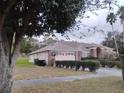 One-story home with brick exterior, landscaping, and a large yard at 3860 Weetamoo Cir, Orlando, FL 32818