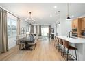 Open concept dining area with hardwood floors and chandelier at 4398 Davos Dr, Clermont, FL 34711