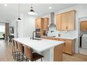 Modern kitchen with light wood cabinets and white countertops at 4398 Davos Dr, Clermont, FL 34711