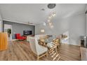 Dining area with glass table, white chairs, and exposed brick wall at 4487 Twinview Ln, Orlando, FL 32814