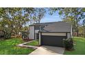 Modern two-story house with a dark-colored garage and walkway at 4940 Spring Run Ave, Orlando, FL 32819